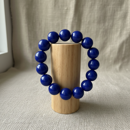 Cobalt blue bracelet on wood cylinder stand
