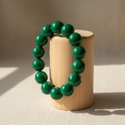 Emerald green bracelet on wood cylinder stand
