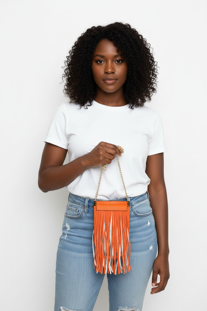 Model holding Orange Fringe Mini Bag