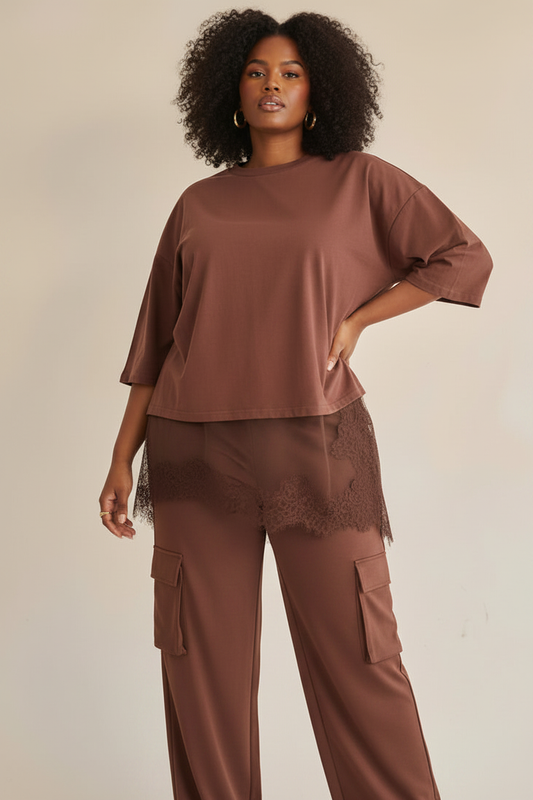 Black curvy female model wearing brown lace trim tee with brown cargo pants