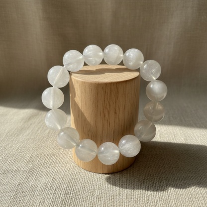 White moonstone bracelet on wood cylinder stand